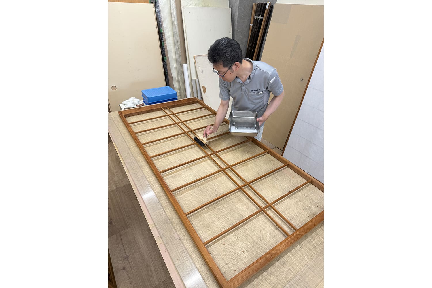 中国・唐の時代に生まれたといわれる表具を制作中の職人
